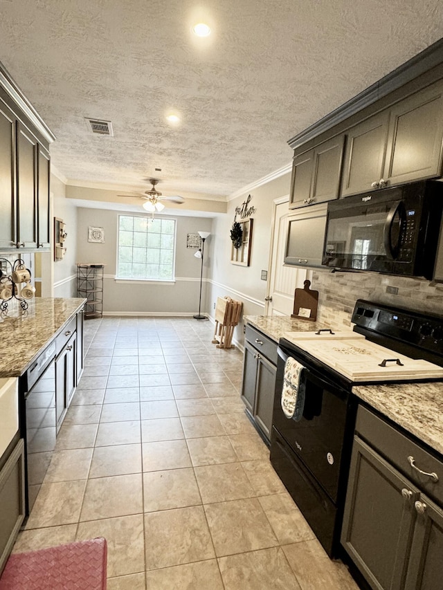 kitchen featuring light stone countertops, ornamental molding, ceiling fan, black appliances, and light tile patterned floors