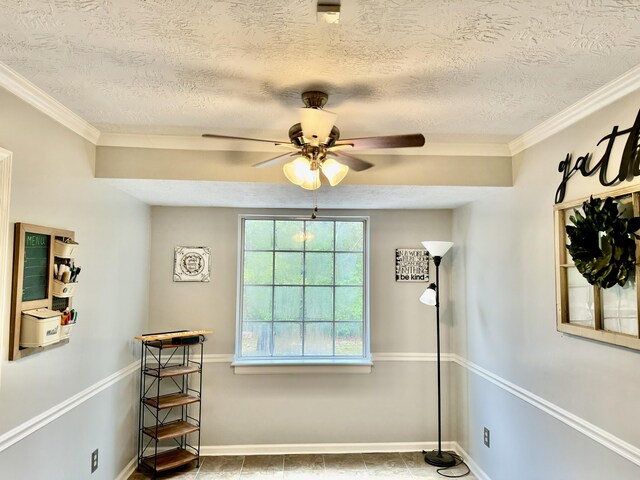 interior space with crown molding, ceiling fan, and a textured ceiling