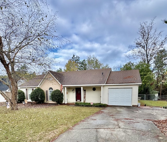 ranch-style home with a front yard and a garage