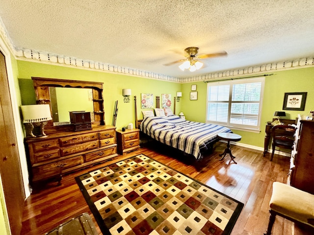 bedroom with hardwood / wood-style floors, a textured ceiling, and ceiling fan