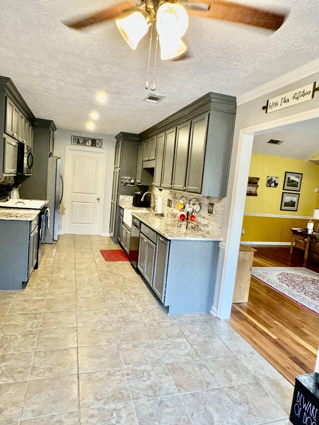 kitchen featuring a textured ceiling, white electric range oven, crown molding, and stainless steel refrigerator