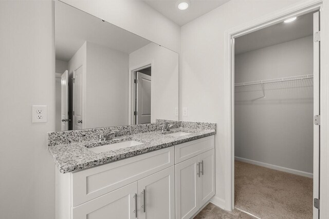 2885 Saltwater Bnd, Beech Island, SC 29842 - bathroom with a sink, baseboards, double vanity, and a spacious closet