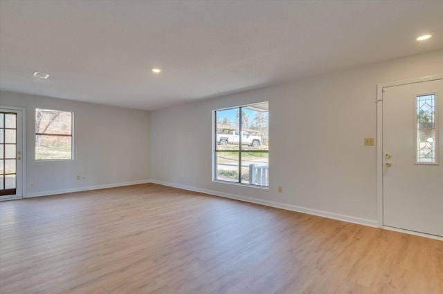 interior space featuring light wood-type flooring, baseboards, visible vents, and recessed lighting