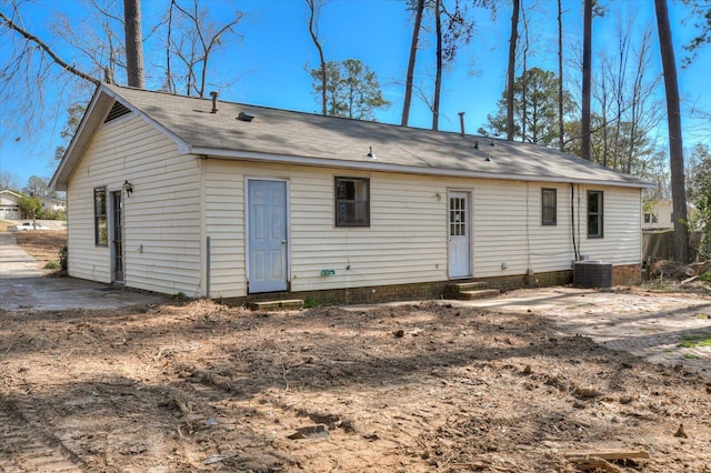 back of house featuring entry steps and central AC unit