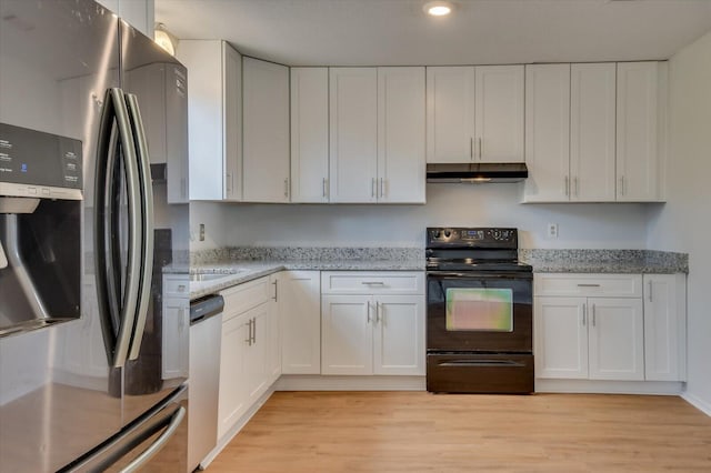 kitchen with stainless steel appliances, white cabinetry, and under cabinet range hood