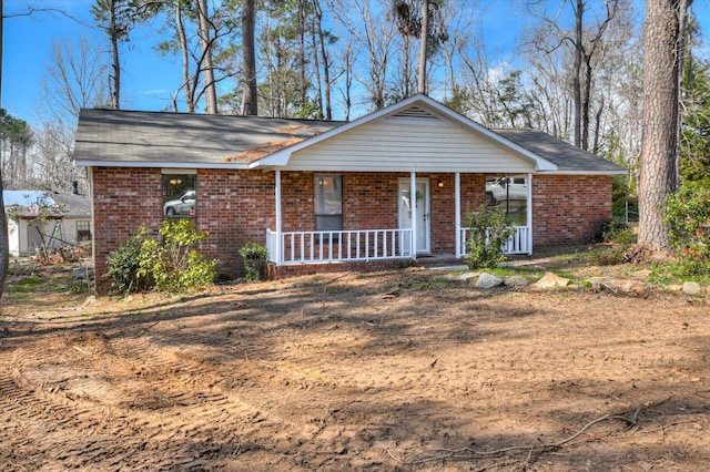 ranch-style home with covered porch and brick siding