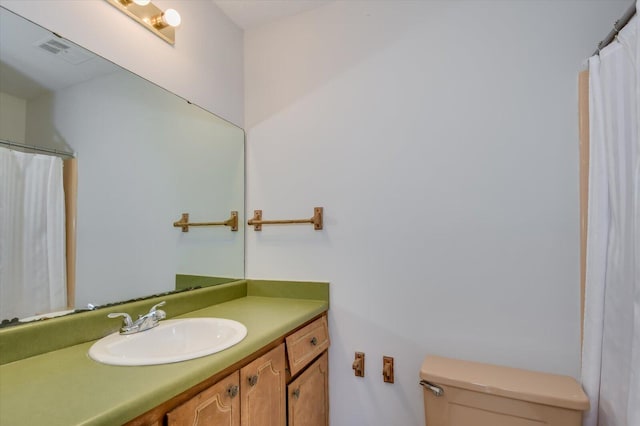 bathroom featuring visible vents, vanity, and toilet