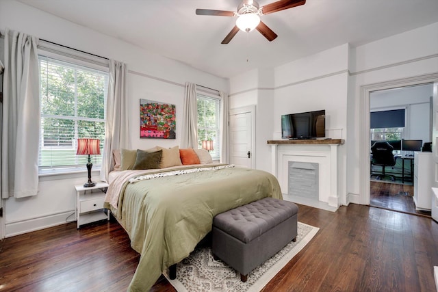 1544 Schley St, Augusta, GA 30904 - bedroom featuring wood finished floors, baseboards, a fireplace with flush hearth, and a ceiling fan