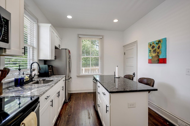 1544 Schley St, Augusta, GA 30904 - kitchen with dark wood-style flooring, appliances with stainless steel finishes, dark stone counters, healthy amount of natural light, and recessed lighting
