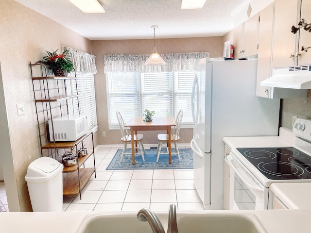 317 Coastal Cv, Mccormick, SC 29835 - kitchen with a textured ceiling, white cabinetry, pendant lighting, and white appliances