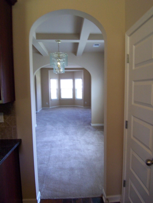 2103 Kaneck Way, Hephzibah, GA 30815 - hall with arched walkways, coffered ceiling, beam ceiling, a chandelier, and carpet flooring