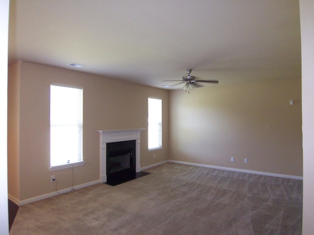2103 Kaneck Way, Hephzibah, GA 30815 - unfurnished living room featuring carpet floors, a ceiling fan, a fireplace with flush hearth, and baseboards
