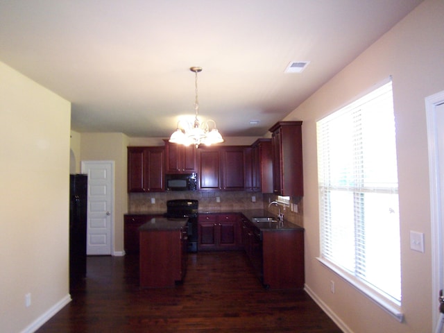 2103 Kaneck Way, Hephzibah, GA 30815 - kitchen featuring black microwave, electric stove, a center island, a chandelier, and decorative backsplash