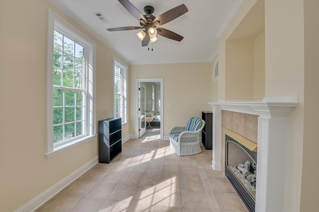 972 Woody Hill Cir, Evans, GA 30809 - sitting room with crown molding, ceiling fan, a tile fireplace, light tile patterned floors, and baseboards