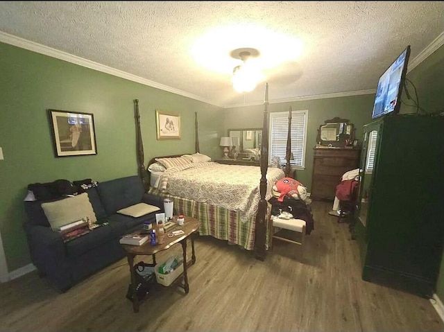 bedroom featuring ornamental molding, a textured ceiling, and wood finished floors