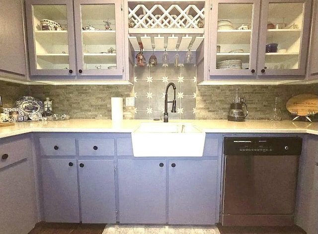 bar with decorative backsplash, stainless steel dishwasher, wet bar, and a sink