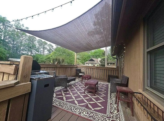 wooden deck with an outdoor living space