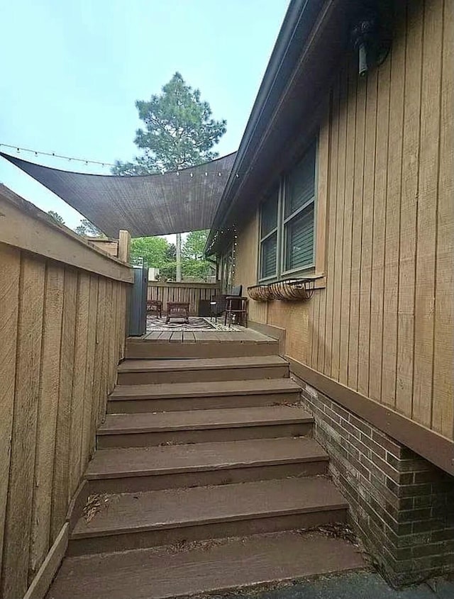 view of side of home with a deck and stairway