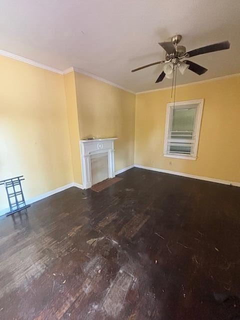 unfurnished living room with baseboards, a fireplace, and ornamental molding