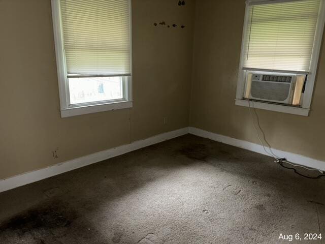 carpeted spare room featuring cooling unit