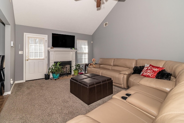 living area with visible vents, a fireplace with flush hearth, carpet flooring, ceiling fan, and baseboards