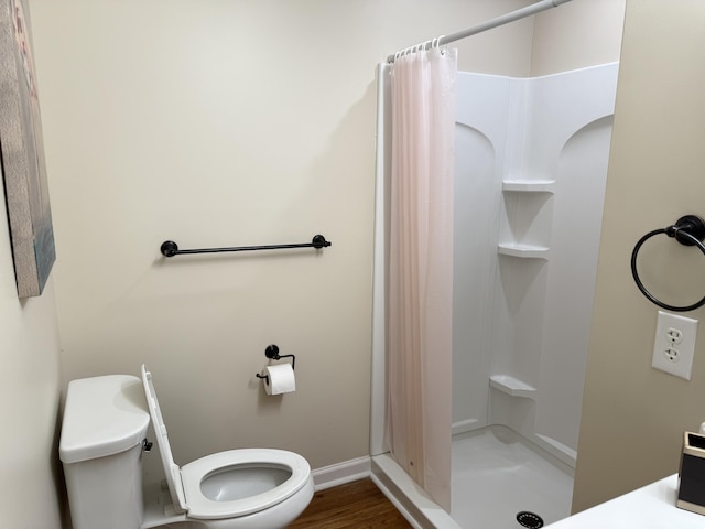 410 Johns Rd, Thomson, GA 30824 - bathroom with toilet, a shower stall, baseboards, and wood finished floors