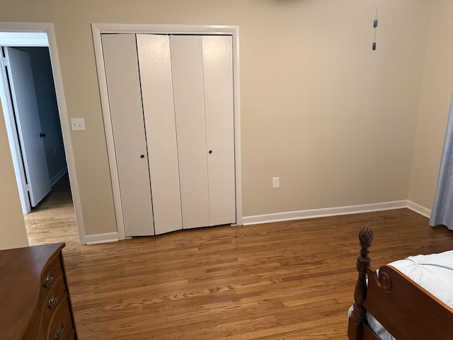 410 Johns Rd, Thomson, GA 30824 - bedroom featuring baseboards, light wood-style flooring, and a closet