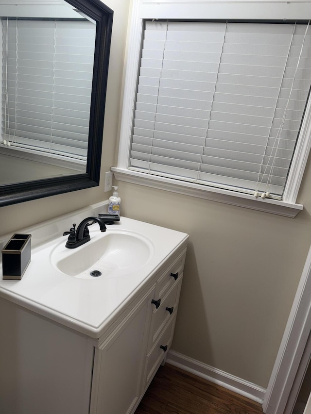 410 Johns Rd, Thomson, GA 30824 - bathroom with vanity, wood finished floors, and baseboards