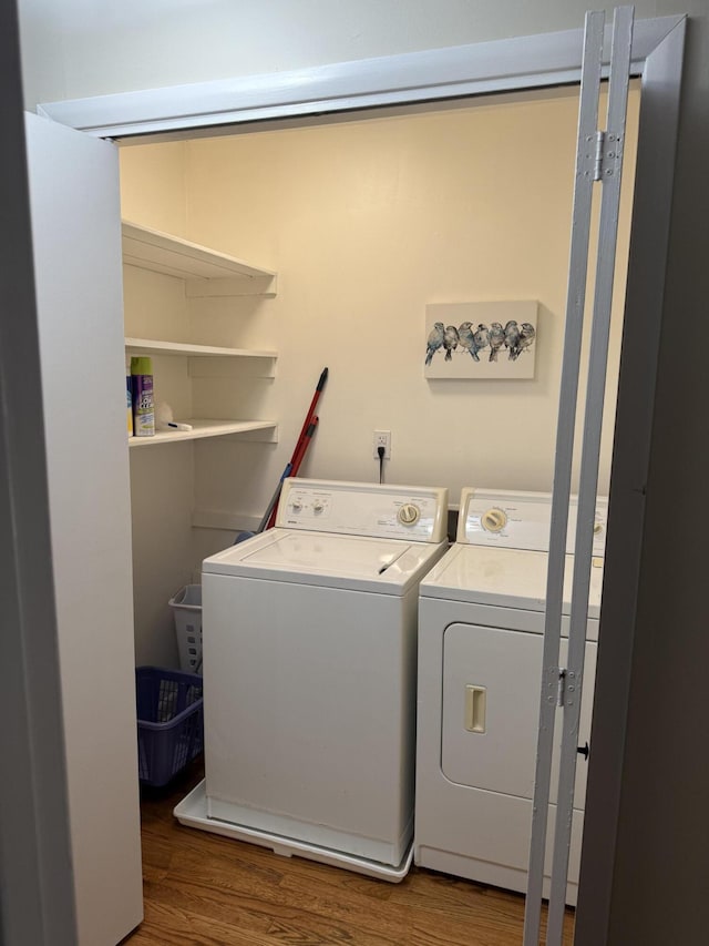 410 Johns Rd, Thomson, GA 30824 - laundry room with wood finished floors and washing machine and dryer