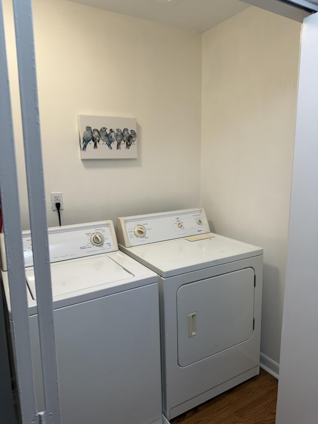 410 Johns Rd, Thomson, GA 30824 - laundry room featuring washer and dryer and dark wood-style flooring