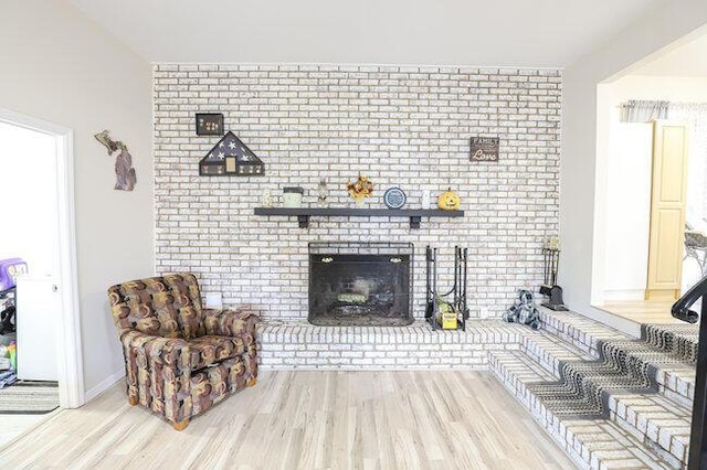 living room featuring a fireplace and light hardwood / wood-style flooring