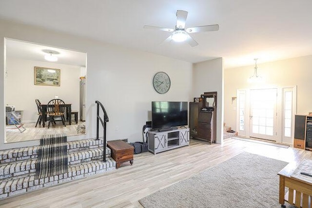 living room with light hardwood / wood-style floors and ceiling fan