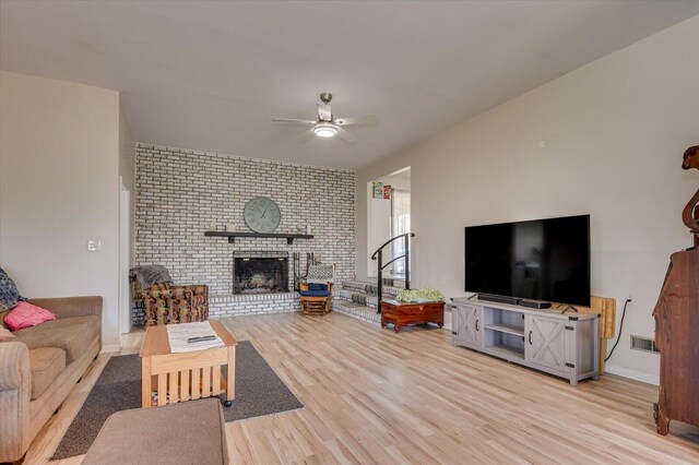 2107 Brown Rd, Hephzibah, GA 30815 - living area with baseboards, wood finished floors, a brick fireplace, and ceiling fan