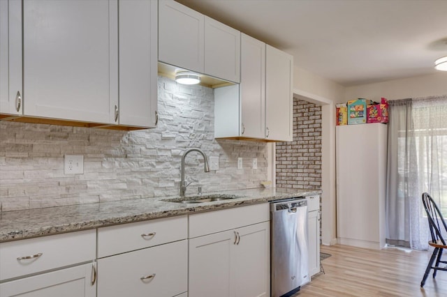 2107 Brown Rd, Hephzibah, GA 30815 - kitchen featuring light stone countertops, white cabinetry, a sink, decorative backsplash, and dishwasher