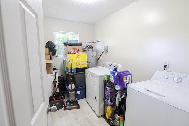 laundry room featuring washing machine and clothes dryer and electric water heater