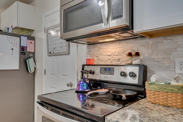 2107 Brown Rd, Hephzibah, GA 30815 - kitchen with decorative backsplash, white cabinets, stainless steel appliances, and light countertops