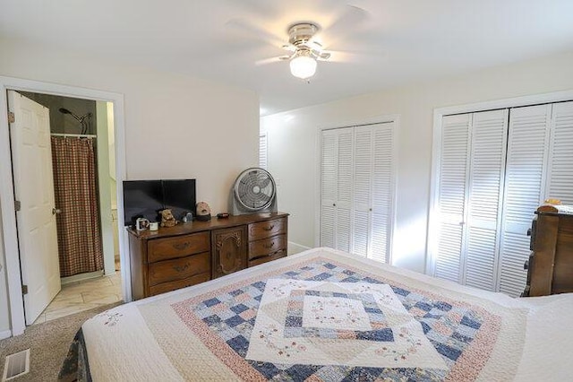 bedroom with multiple closets, ceiling fan, and ensuite bath