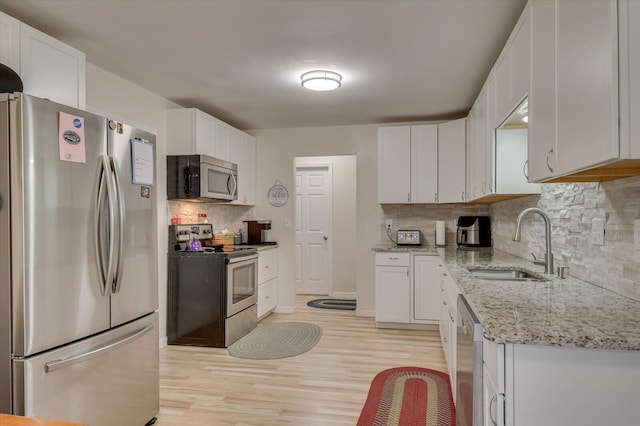 2107 Brown Rd, Hephzibah, GA 30815 - kitchen with a sink, white cabinetry, and stainless steel appliances