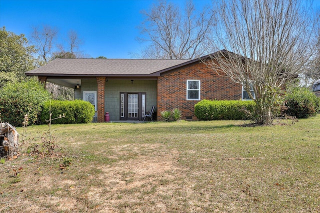 view of front of home with crawl space, brick siding, a front yard, and a shingled roof