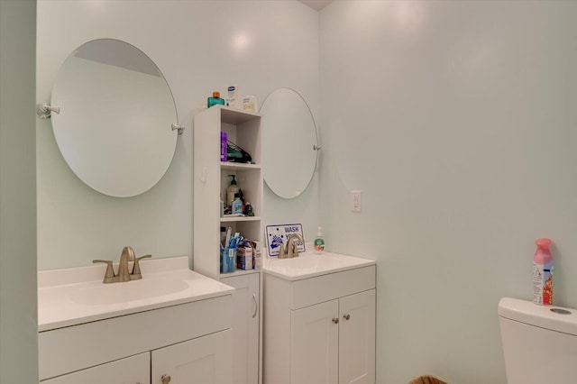 2107 Brown Rd, Hephzibah, GA 30815 - bathroom with toilet, two vanities, and a sink