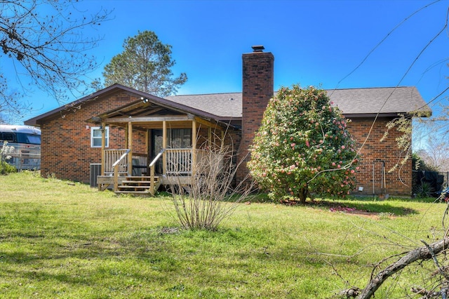 2107 Brown Rd, Hephzibah, GA 30815 - back of property with brick siding, a lawn, a porch, and a chimney