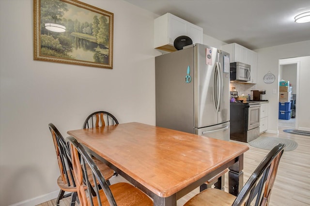 2107 Brown Rd, Hephzibah, GA 30815 - dining area with baseboards and light wood-style floors