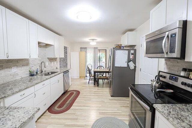 kitchen featuring white cabinetry, appliances with stainless steel finishes, and sink