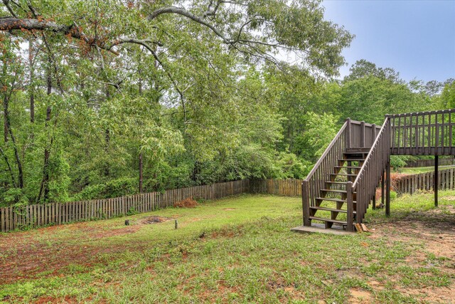 2669 Corning St, Hephzibah, GA 30815 - view of yard featuring stairway, a deck, and a view of trees