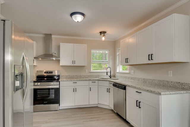 2669 Corning St, Hephzibah, GA 30815 - kitchen featuring appliances with stainless steel finishes, wall chimney range hood, a sink, white cabinetry, and ornamental molding