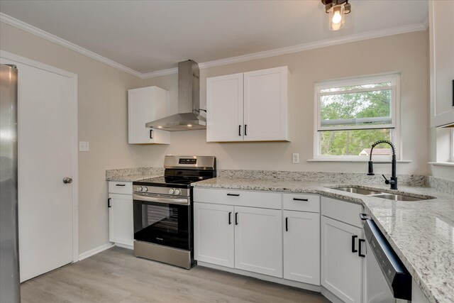 2669 Corning St, Hephzibah, GA 30815 - kitchen featuring appliances with stainless steel finishes, wall chimney range hood, a sink, light wood finished floors, and white cabinets