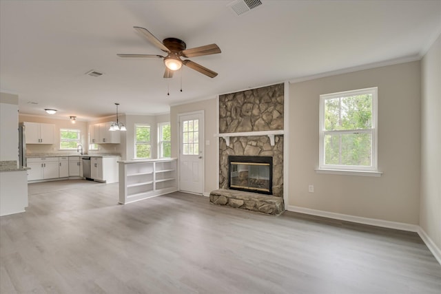2669 Corning St, Hephzibah, GA 30815 - unfurnished living room with crown molding, a ceiling fan, a fireplace, light wood-style floors, and baseboards