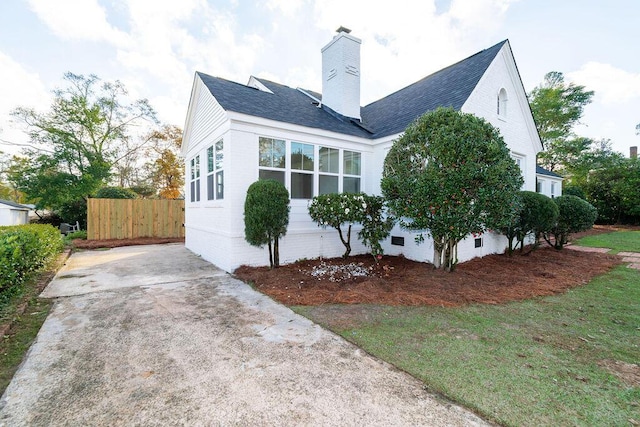 rear view of house featuring a lawn