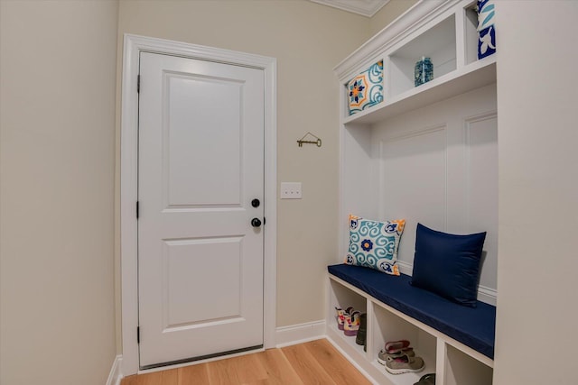 mudroom with crown molding and light hardwood / wood-style flooring