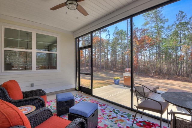 sunroom / solarium featuring ceiling fan